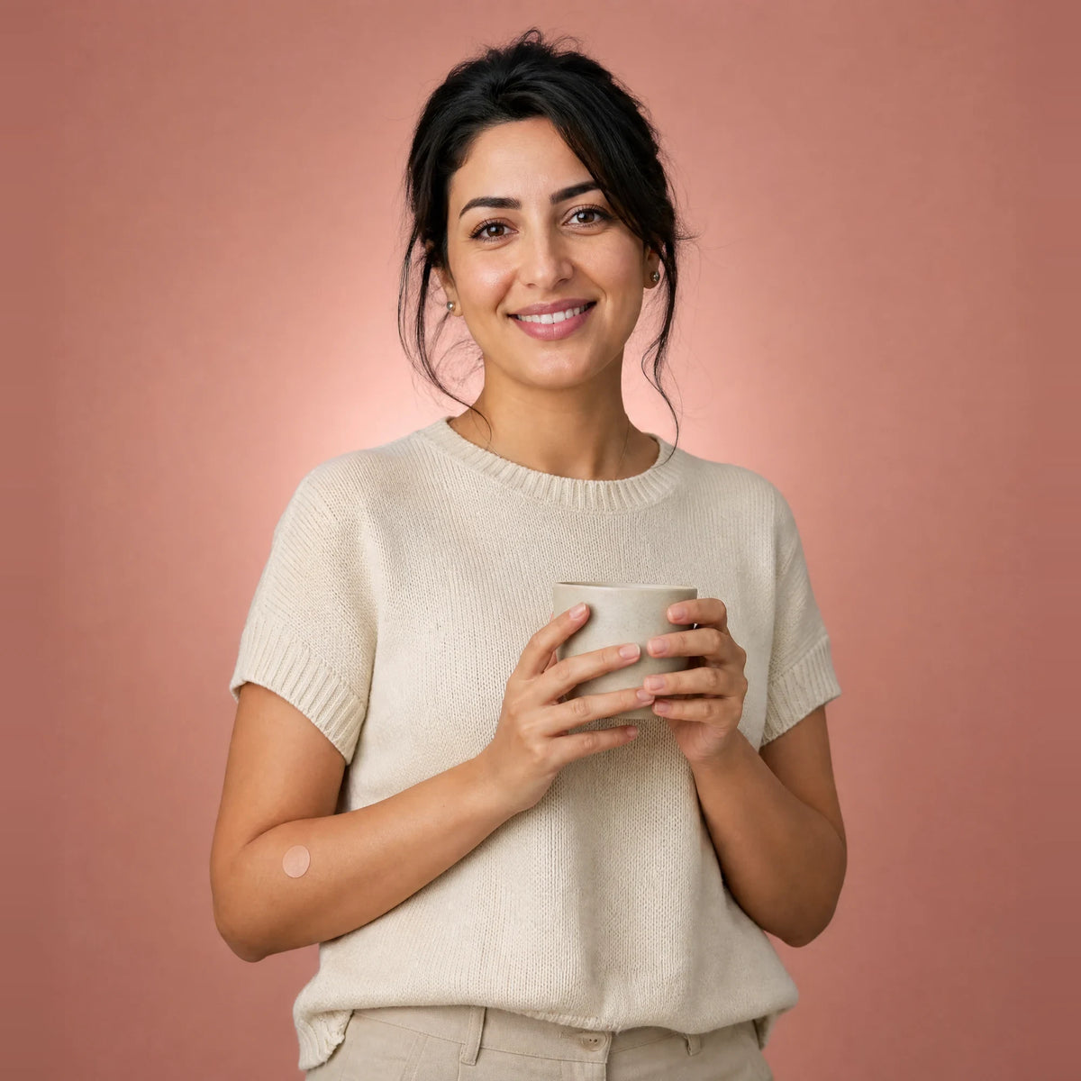 Smiling woman with a small plaster on her arm after a home blood test