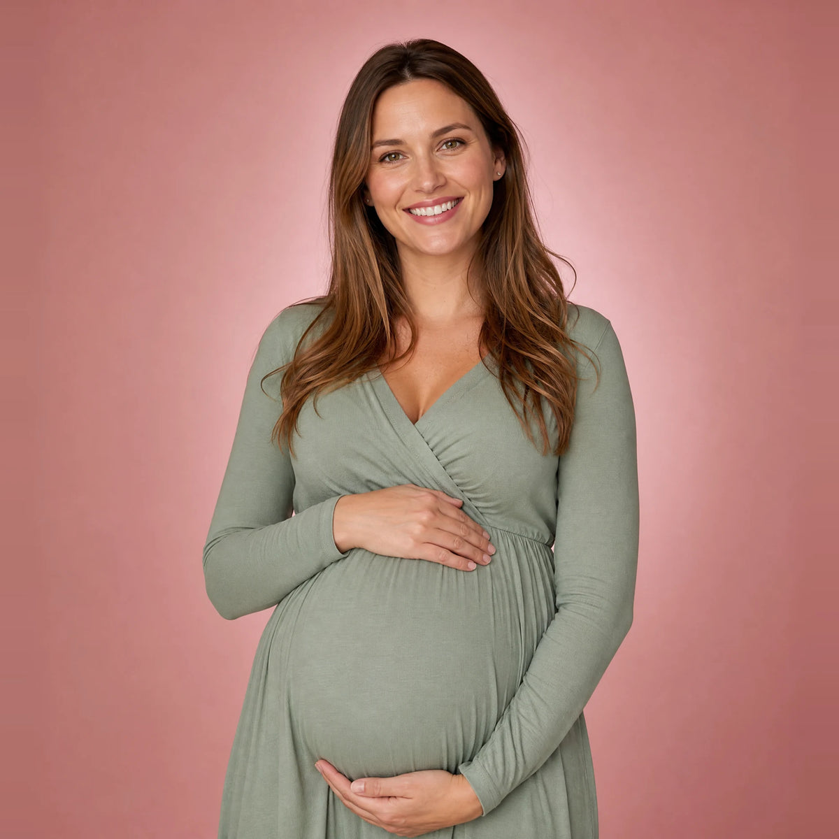 Smiling pregnant woman with her hands on her belly